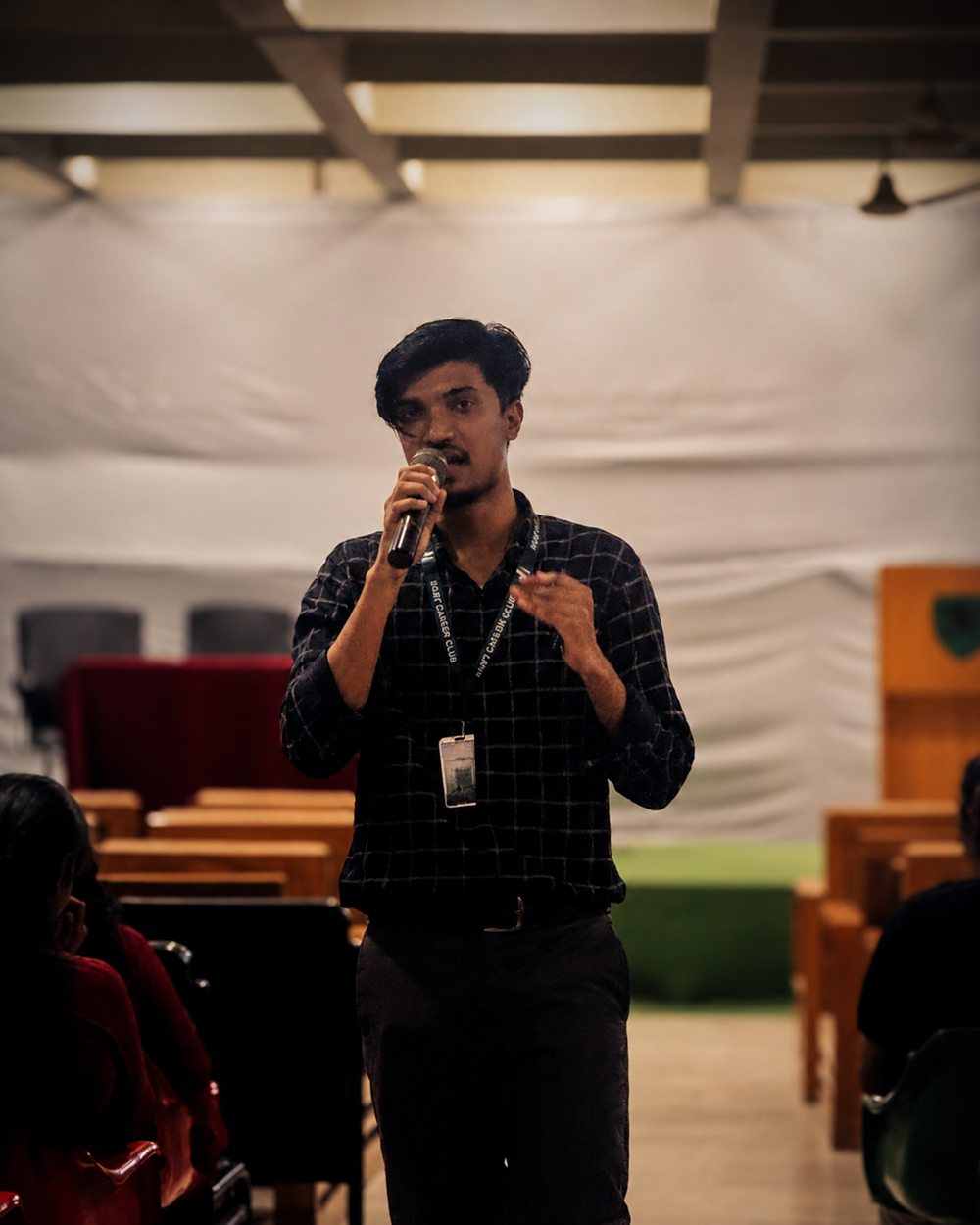 Shadman Rahman speaking with microphone at a KUET Career Club event